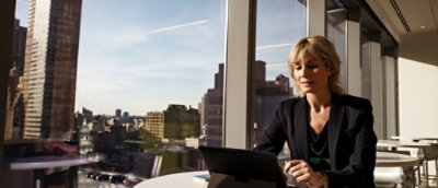 A woman looking at a laptop.