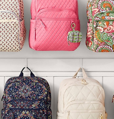 Six backpacks in various colors and patterns arranged in two rows, including quilted, floral, paisley, and geometric designs.