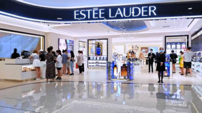 A man and woman discussing using a laptop.