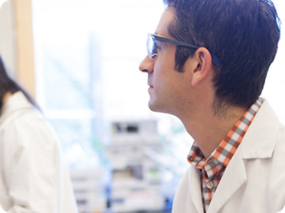 A young man in a lab coat
