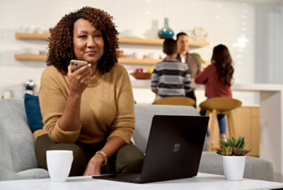 A person sitting on a couch using a laptop.