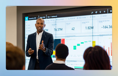 A man standing in front of a large screen displaying numbers and text.