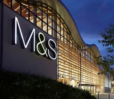 A building with a sign on the side displaying M&S.