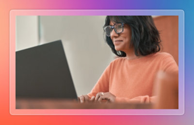 Woman using laptop with extra monitor