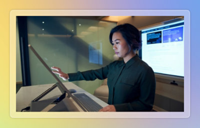 Person interacting with a large touchscreen workstation.