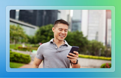 A man holding a phone and looking at the screen.