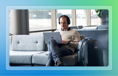 A man sitting on a couch using a laptop.