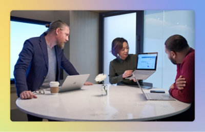 A man and woman looking at a laptop.