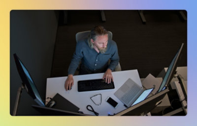 A man sitting at a desk using a computer.