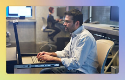 A man in a white shirt using a laptop.