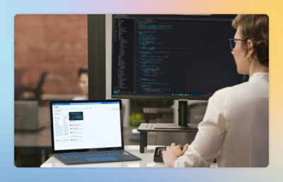 A man sitting at a desk with a laptop.