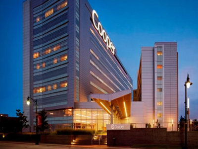 Cooper hospital campus exterior at night.