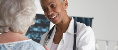 Clinician consulting patient in exam room