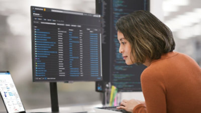 A person sitting down looking at a computer screen.