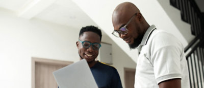 Two man looking at laptop.