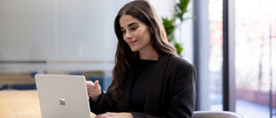 woman sitting in office environment and looking at the screen