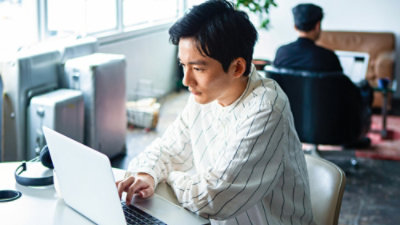 A man working on a laptop.