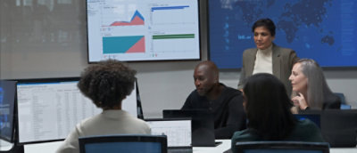 A group of people sitting around a table in a meeting room.