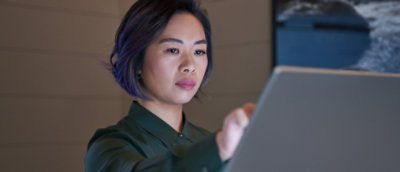 A woman looking into a computer.