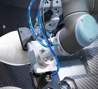 Close-up view of a robotic arm with blue tubing and metallic components designed for precision tasks.