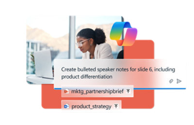 A woman with glasses sitting at a desk with a white laptop.