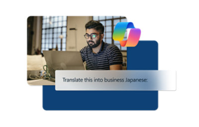 A man wearing glasses sitting at a desk with a laptop.