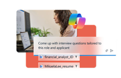 A woman with brown hair sitting at a computer.