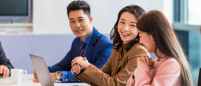 A group of people sitting at a table in a room.