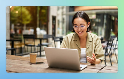 A woman sitting at a table with a laptop.