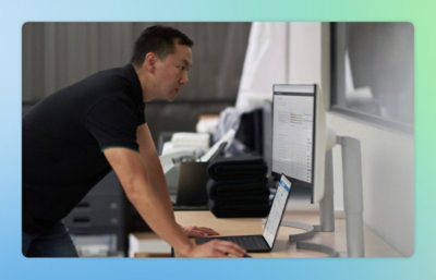 A person using a laptop at a desk.