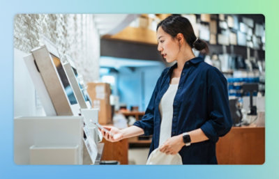 A person standing next to a machine with a row of white rectangular objects.