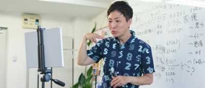 Person teaching via tablet in a classroom setting