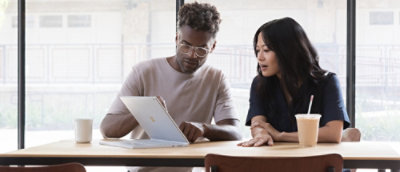 A man showing a tab screen to a other person.