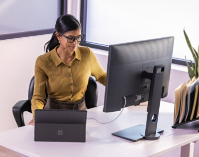 A women working with a desktop in office.
