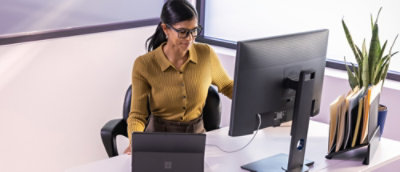 A person sitting at a desk looking at a computer screen.