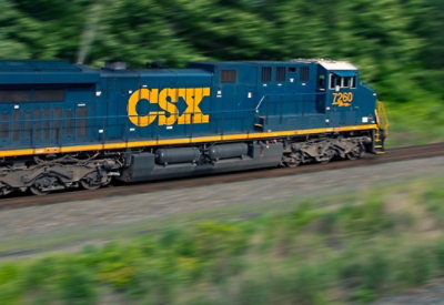 A blue and yellow train with CSX 2260 written on it is on the tracks.
