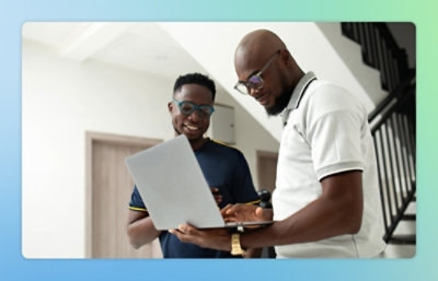 A man wearing a white shirt holding a laptop.