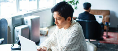 A person sitting in front of a laptop.