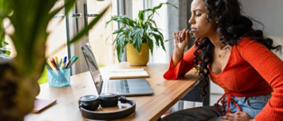 A woman sitting at a desk with a laptop.