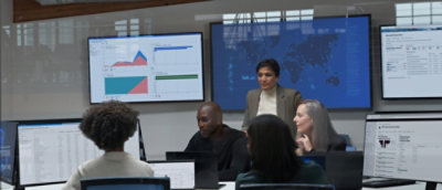 A group of people talking with eatch other in a meeting room.