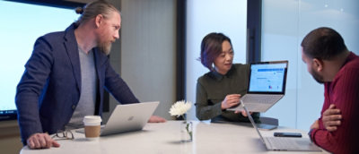 A women showing something on screen tab to a man.