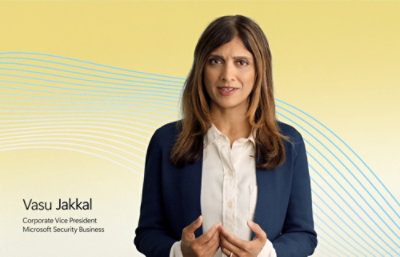 Presenter standing in front of a screen with security icons.