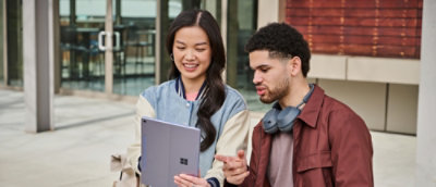 A women and a man checking something in a laptop
