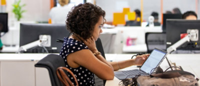 A women working on her desk with laptop.