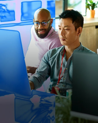 Kaks inimest töötavad arvutiga.