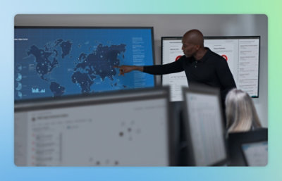 Team reviewing data on large monitoring screens.