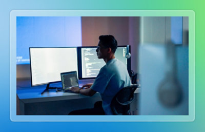 A man sitting at a desk using a laptop.