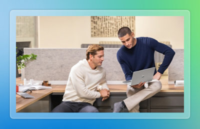 Two people looking at the laptop.