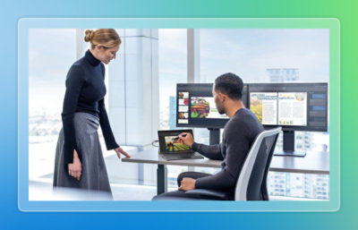 A man and woman looking at a laptop.