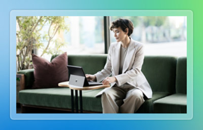 A person sitting on a couch using a laptop.